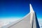 Boeing White Wing Over White Air Clouds And Clear Blue Sky. High quality photo