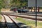 The bogie low-sided wagon is parked in the railway yard of the urban station