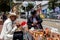 Bogota, Colombia - July 2nd 2023. Senior artisans selling pretty handmade birds made from seeds on the streets of downtown Bogota