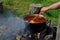 Bograch. Soup with paprika, meat, bean, vegetable, dumpling. Traditional Hungarian Goulash in cauldron. Meal cooked outdoors on an