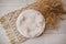 Bohemian rustic newborn background - white bowl with macrame and dry wheat on white wooden floor