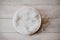 Bohemian rustic newborn background - white bowl with macrame and dry wheat on white wooden floor