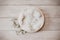 Bohemian rustic newborn background - white bowl with macrame and dry wheat on white wooden floor