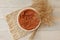 Bohemian rustic newborn background - white bowl with macrame and dry wheat on white wooden floor