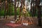 Bohemian tipi arch made of wooden rods decorated with pink roses, candles on carpet, pampass grass, wrapped in fairy