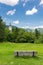 Bohinj church in the Ribcev Laz village, Slovenia. View of old ancient church from the park with bench. Slovenia alps with Triglav