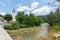 Bohinj church, Slovenia - view of river in the Ribcev Laz village. Tourist on the kayak and canoe on the river. Hiking in the Slov