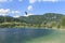 Bohinj, Slovenia - June 4, 2017: Tourist paragliding on lake Bohinj a famous destination not far from lake Bled, in Slovenia