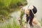 Boho Girl sniffing bouquet of wildflowers.