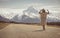 A boho hippy lady in white dress with hat stands on road with aoraki snow mountain background in New Zealand. idea for travel, de