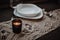 Boho vintage table runner with candle on dark background