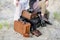 Boho wedding couple sitting on vintage suitcases, near old retro cameras and camera cases.