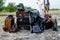 Boho wedding couple standing near vintage suitcases, near old retro cameras, camera cases and old lamp