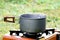 Boil something in pot on gas stove on grass background