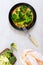 Boiled broccoli on a plate on a light background. Healthy eating concept. Sports diet. Proper nutrition. Healthy lifestyle. Free