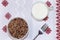 Boiled buckwheat cereal with milk in a bowl on a light table. Traditional Russian organic food, diet food, selective focus, top