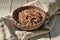 Boiled buckwheat cereal in a pottery bowl on a rustic wooden surface decorated with a linen napkin