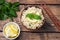 Boiled bulgur with fresh lemon and mint on a plate. A traditional oriental dish called Tabouleh. wooden background rustic top view