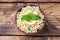 Boiled bulgur with fresh lemon and mint on a plate. A traditional oriental dish called Tabouleh. wooden background rustic top view