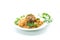 Boiled bulgur groats with vegetables and meatballs in a plate