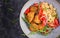 Boiled bulgur, roasted chicken nuggets and fresh tomatoes salad.