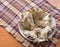 Boiled chicken backs in the plate on the wooden table top on a c