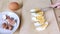 Boiled chicken egg is cut with knife. Protein diet food. Breakfast or healthy snack. Close-up, wooden table