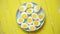 Boiled chicken eggs on a blue ceramic plate. The concept of Easter Holidays