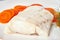 Boiled codfish with carrot and dill on white plate, fodmap dash paleo diet, side view closeup