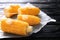 Boiled corncobs on wooden table, closeup