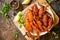 Boiled crawfish, lemon and parsley on a wooden table. Appetizer protein, the concept of healthy eating.