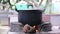 Boiled curry in old black pot with white steam on firewood stove , asian lifestyle