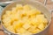 Boiled diced potatoes in an aluminum pan in the kitchen