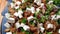 Boiled duck meat salad in salad bowl on wooden table