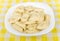 Boiled dumplings in white glass plate on yellow tablecloth