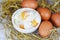 Boiled egg on bowl and fresh eggs on straw background - Soft boiled eggs