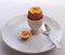 Boiled egg,cut open in eggcup,on plate with spoon