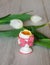 Boiled egg in egg cup with tulips.