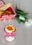 Boiled egg in egg cup with tulips and bread