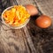 Boiled egg yolk with yellow eggs on wooden table, rustic image