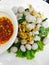 Boiled fish ball with vegetables, fried garlic and spicy sauce