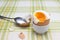 Boiled fresh smash broken egg for the breakfast on the porcelain stand for eggs. Broken beige hen egg and pieces of shells, bright