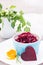 Boiled grated beet in a bowl, chiken egg and parsley