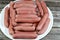 boiled hot dog, dish consisting of a grilled, steamed, or boiled sausage served in the slit of a partially sliced bun, hotdog is