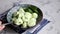 Boiled khinkali made of dough with spinach. Garnished with Red Chilli, Dill and Parsley. On a light gray background under