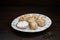 Boiled lamb dumplings with garlic sauce on a plate in a restaurant. Hot national dishes.