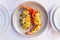 Boiled Lobster with cheese served with Spaghetti Carbonara decorated with flowers and petals in white plate