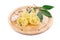 Boiled lumaconi pasta on wood platter.