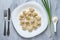 Boiled meat dumplings served with sour cream and chives.