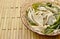 Boiled mixed mushroom with star gooseberry in spicy soup on glass bowl